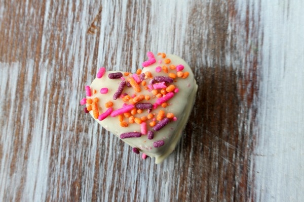 chocolate chocolate chip cookie dough truffle heart shaped with sprinkles on top