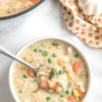creamy chicken and rice soup in bowl with spoon