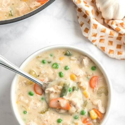 creamy chicken and rice soup in bowl with spoon