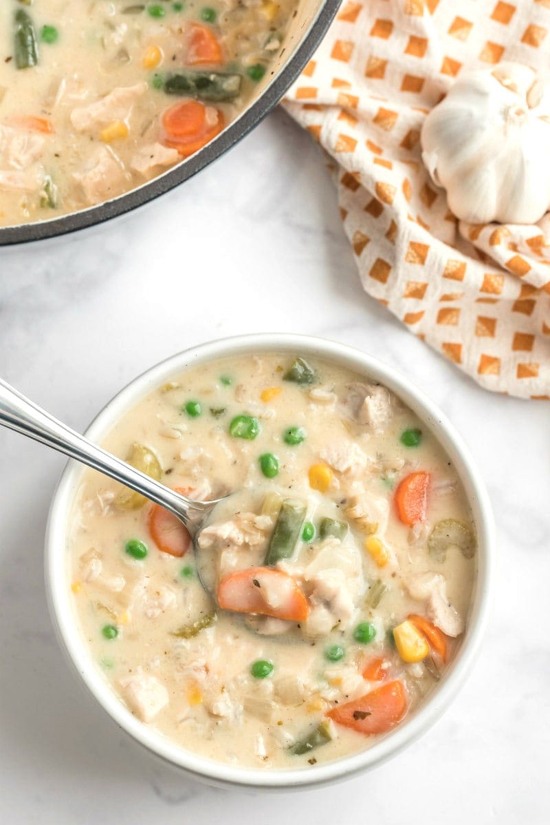 creamy chicken and rice soup in bowl with spoon