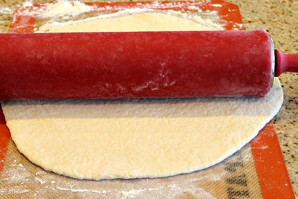 pizza crust red rolling pin rolling out pizza crust