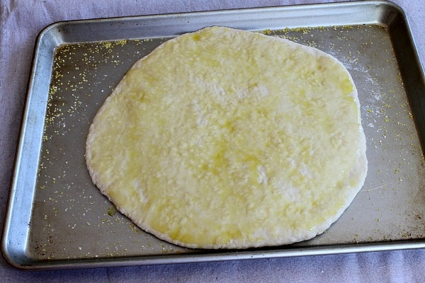 Pizza crust on baking sheet