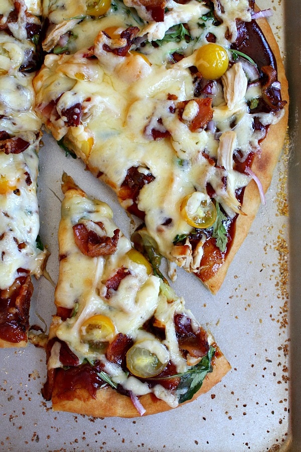BBQ Chicken and Bacon Pizza recipe from RecipeGirl.com #bbq #barbecue #chicken #bacon #pizza #RecipeGIrl BBQ Chicken and Bacon Pizza with slice out of it