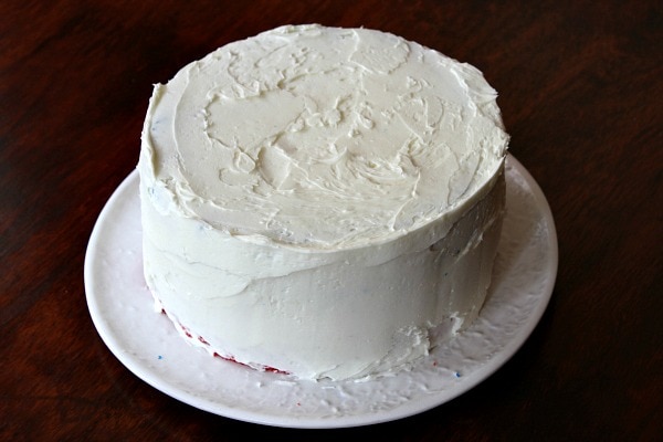 white frosted layer cake on a white plate