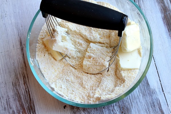 Cutting butter into dry ingredients in a bowl Cutting butter into dry ingredient in a bowl