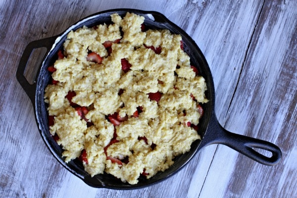 Strawberry Shortcake Skillet Cobbler in black iron skillet ready for oven