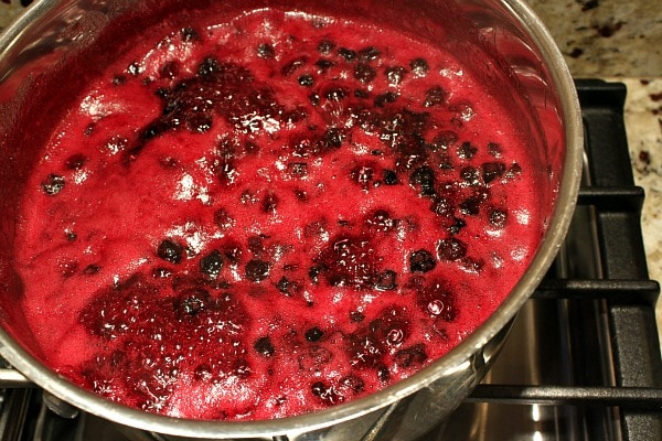 Blueberry Jam bubbling in a pot on the stove