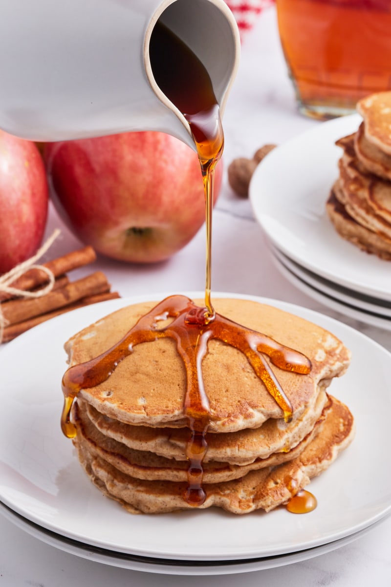 pouring syrup onto pancakes