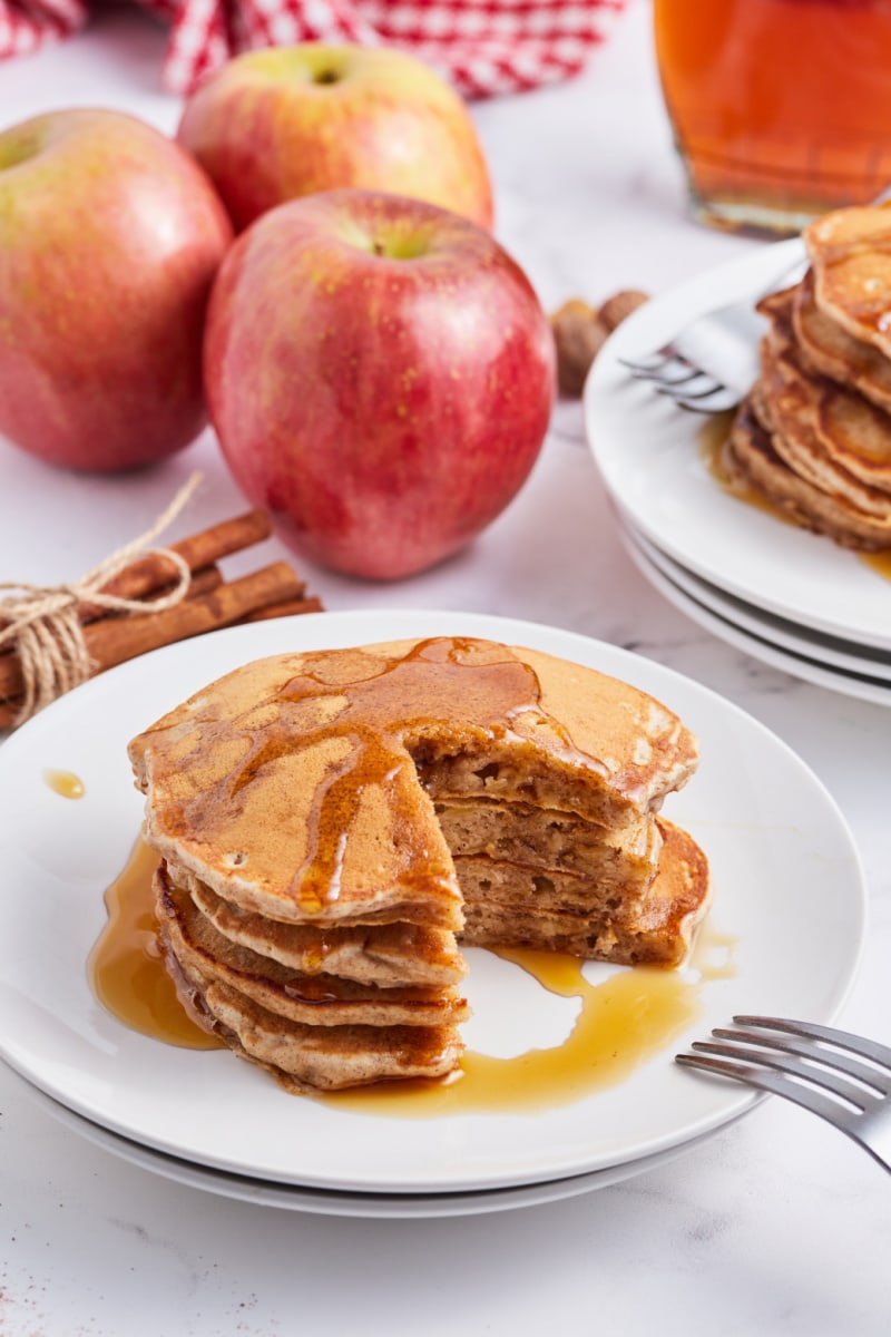 apple pie pancakes with piece cut out of it on plate
