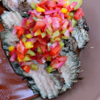 grilled flank steak topped with salsa