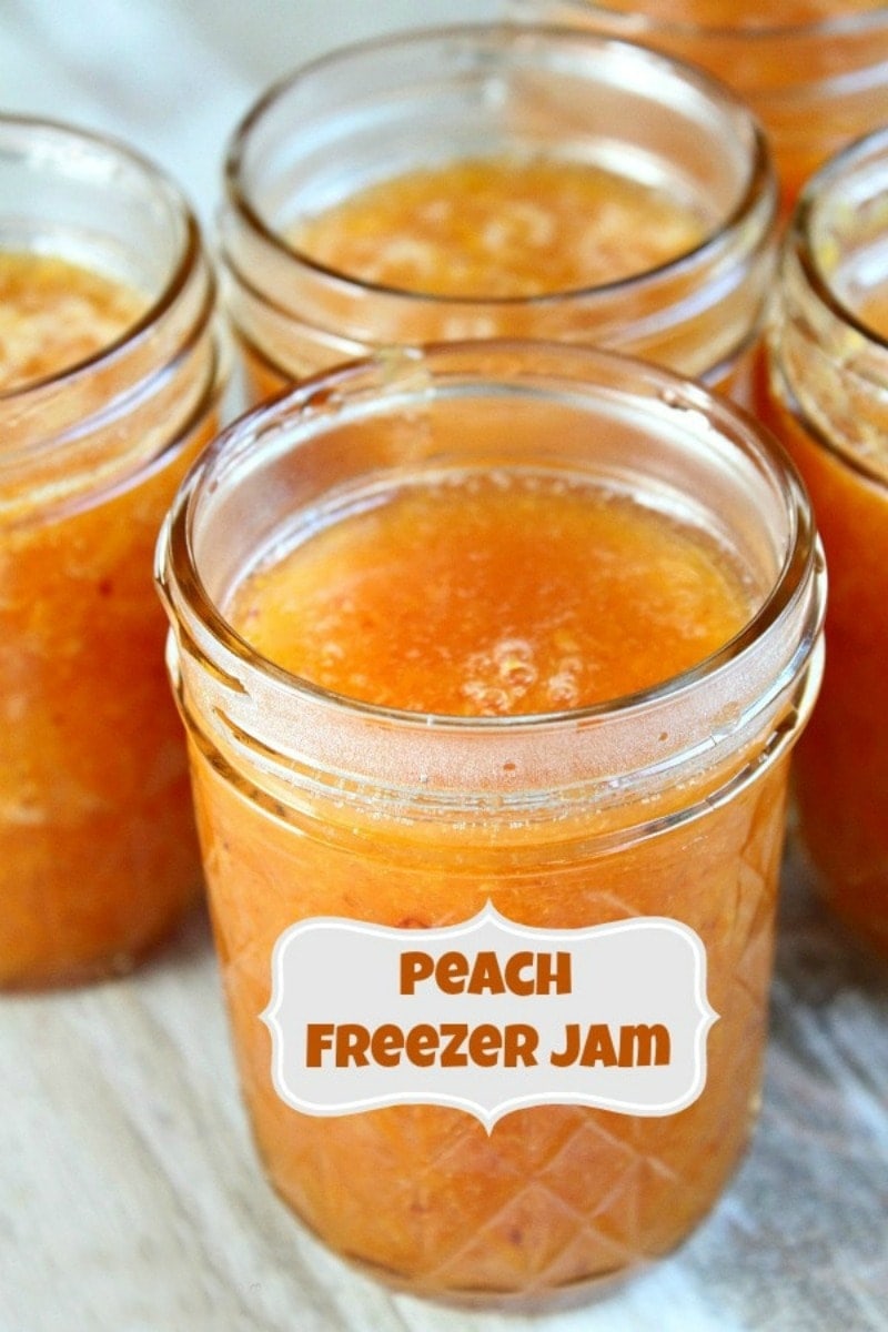 peach freezer jam with a label and several more jars of peach jam in the background.