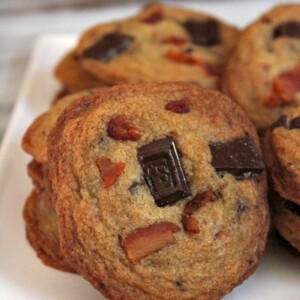 bacon bourbon chocolate chunk cookies displayed on a white plate