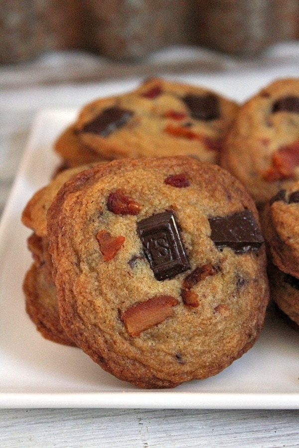 bacon bourbon chocolate chunk cookies displayed on a white plate