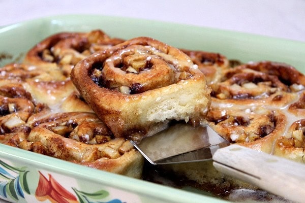 spatula lifting No Yeast Apple Cinnamon Roll in a green dish