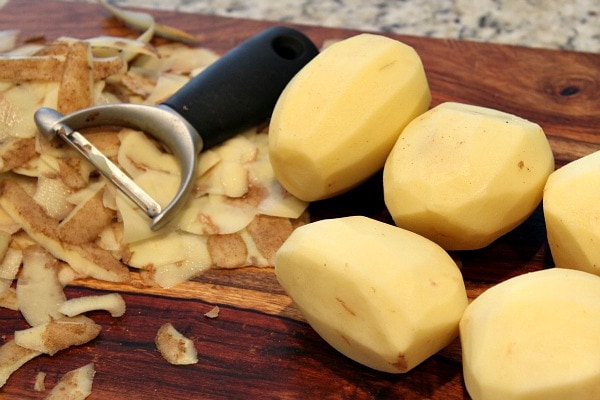 Perfect Mashed Potatoes recipe from RecipeGirl.com #perfect #mashed #potatoes #recipe #RecipeGirl peeling potatoes