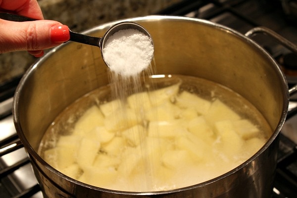 Perfect Mashed Potatoes recipe from RecipeGirl.com #perfect #mashed #potatoes #recipe #RecipeGirl Adding salt to potatoes in water in pan