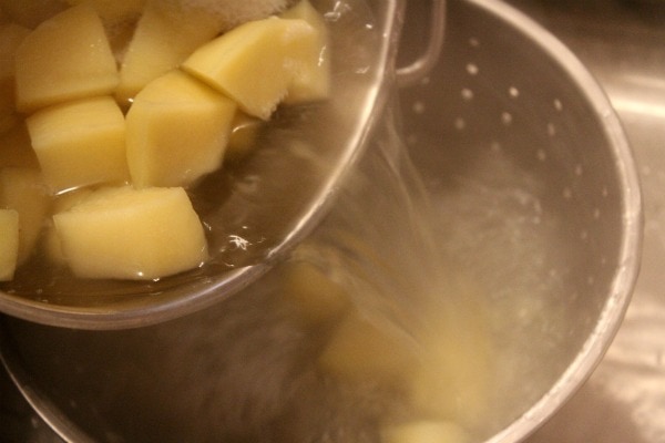 pouring potatoes into a strainer