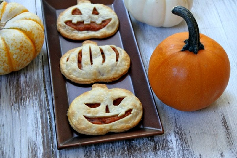 pumpkin pie pop tarts on a tray with pumpkin in background