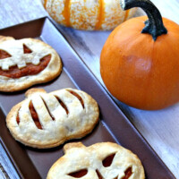 pumpkin pie pop tarts on a tray with pumpkins in background