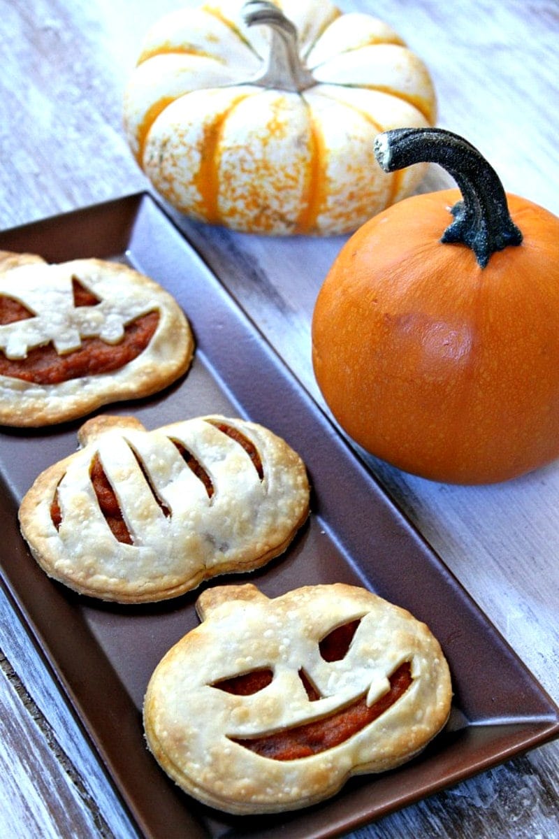 pumpkin pie pop tarts on a tray with pumpkins in background