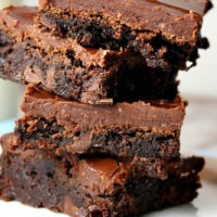 stack of fudgy frosted brownies