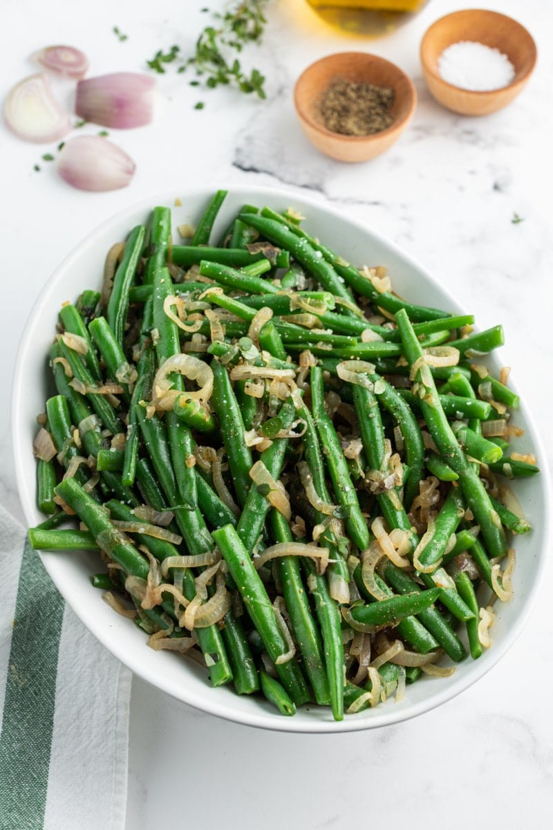 green beans with caramelized shallots in baking dish