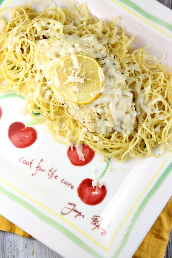 Lemon Chicken Parmesan over pasta on a plate