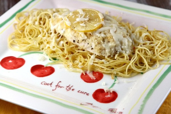 Lemon Chicken Parmesan recipe from RecipeGirl.com #lemon #chicken #parmesan #recipe #RecipeGirl Lemon Chicken Parmesan over pasta on a plate