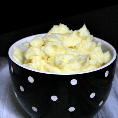 perfect mashed potatoes in a black and white bowl
