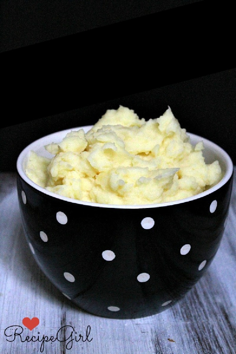 Perfect Mashed Potatoes recipe from RecipeGirl.com #perfect #mashed #potatoes #recipe #RecipeGirl perfect mashed potatoes in a black and white bowl