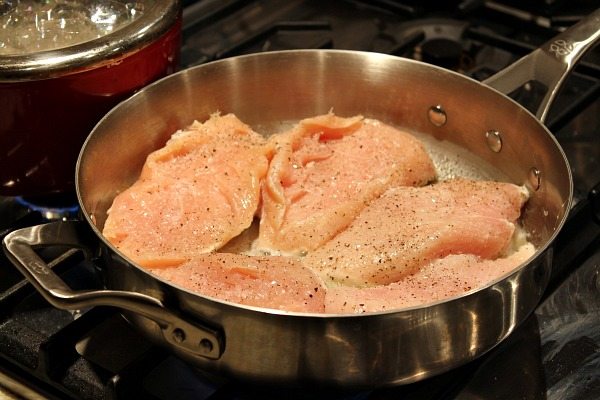 chicken frying in pan