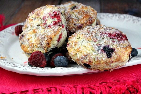 Berry Scones on a white serving platter set on a bright pink cloth napkin