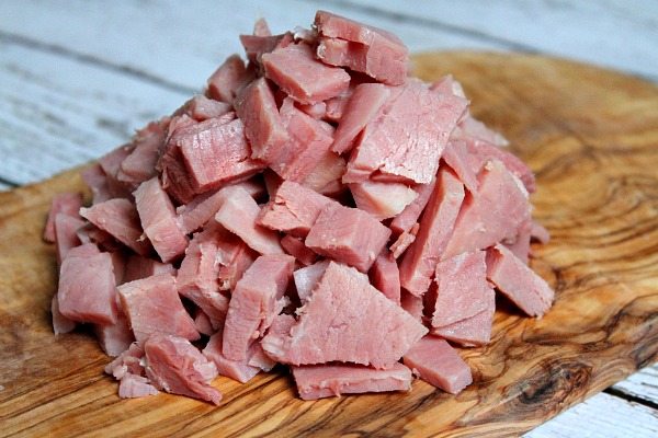 Leftover chopped ham in a pile on cutting board