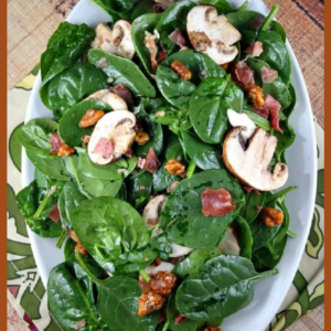 pinterest image for spinach salad on a white plate