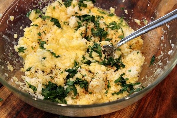 mixing ingredients for cauliflower tortillas in a glass bowl