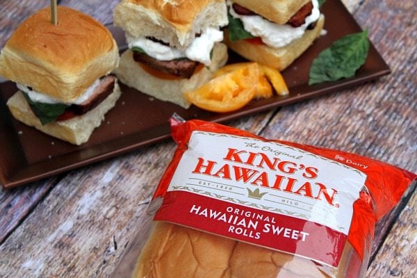 filet mignon caprese sliders on a tray with package of king's hawaiian rolls in the forefront
