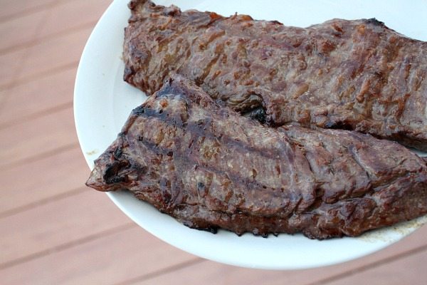 Marinated, Grilled Skirt Steak on a white serving platter