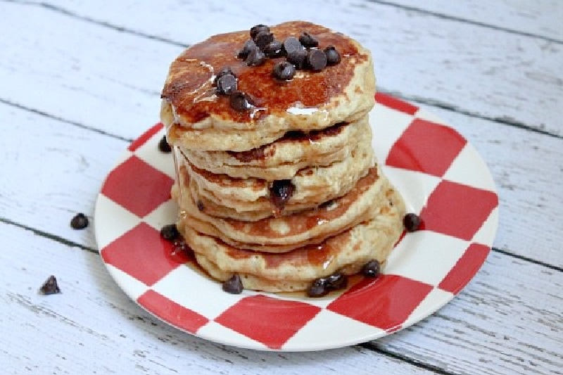 stack of pancakes on a red/white checked plate