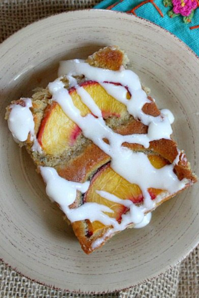 slice of fresh peach cake on a beige plate