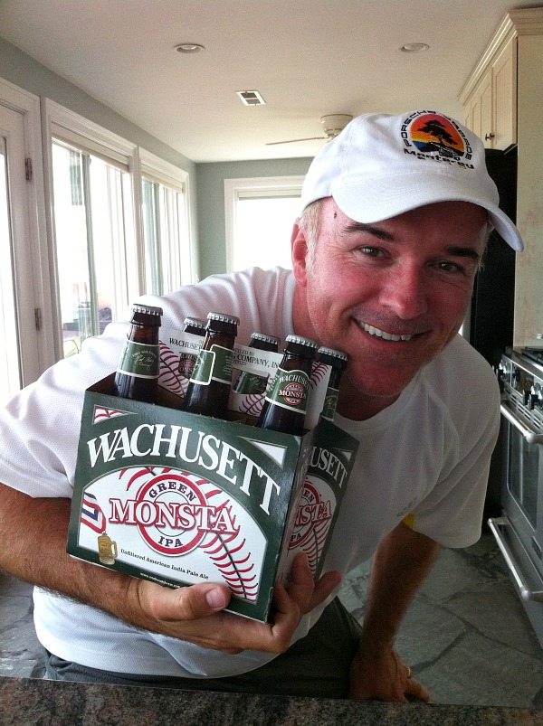 Man with baseball hat holding Green Monsta beer