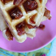 maple bacon waffles on pink plate
