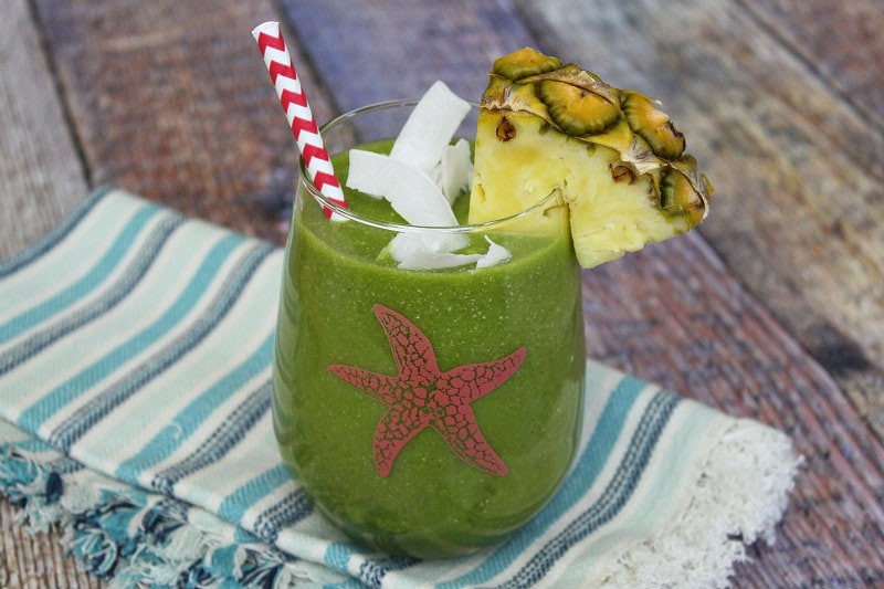 Tropical Green Smoothie with coconut and pineapple garnish