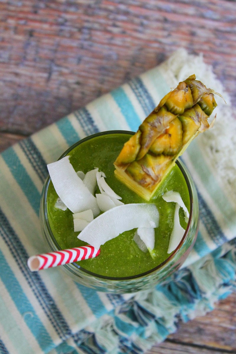 Tropical Green Smoothie with coconut and pineapple garnish