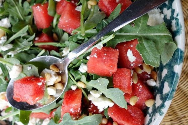 overhead shot close up of watermelon feta salad in a blue and white bowl