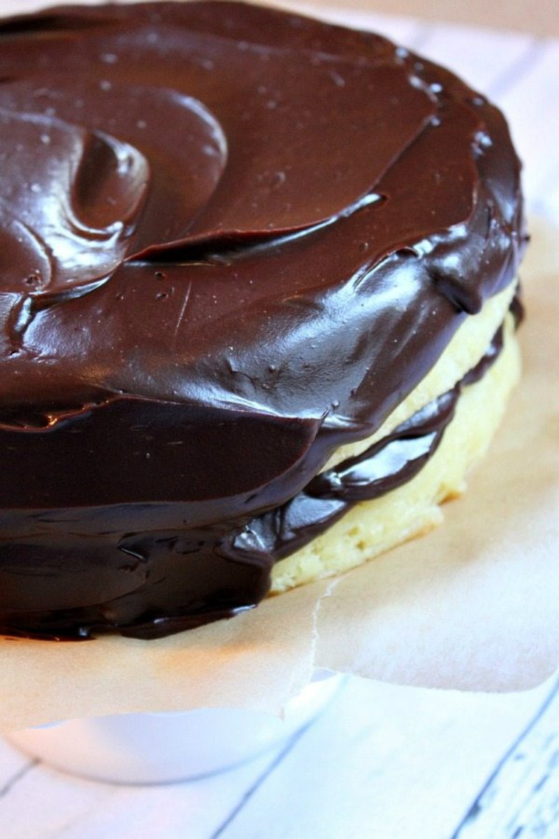 Adding chocolate frosting to yellow cake