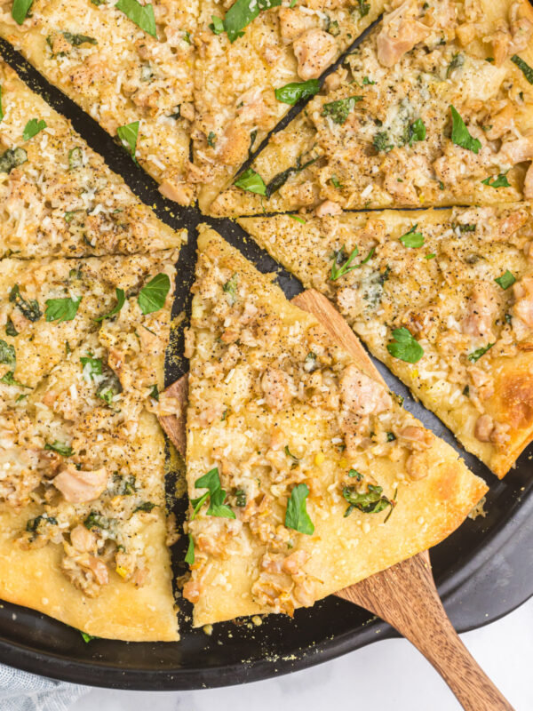 white clam pizza sliced into pieces