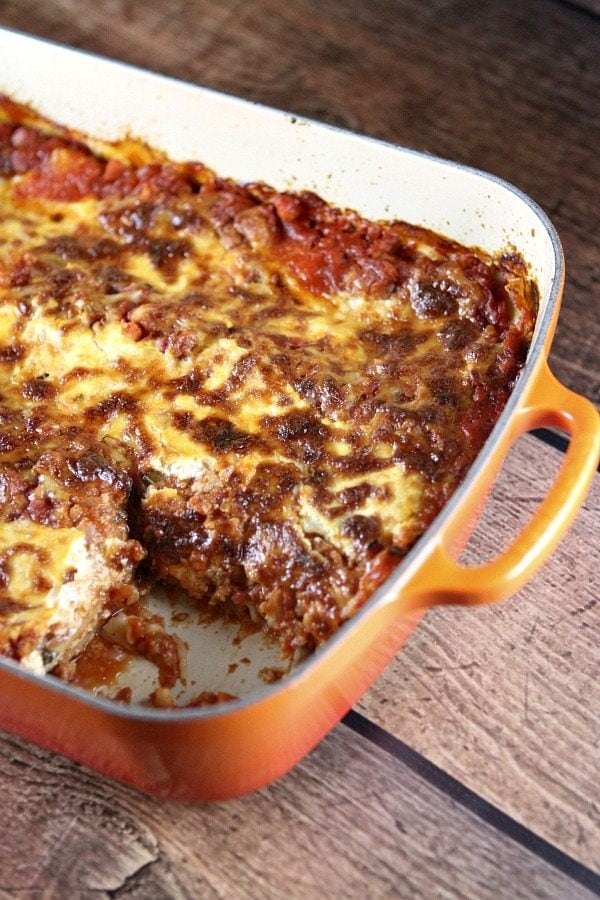 Classic Light Lasagna recipe from RecipeGirl.com lasagna in a pan with a piece cut out
