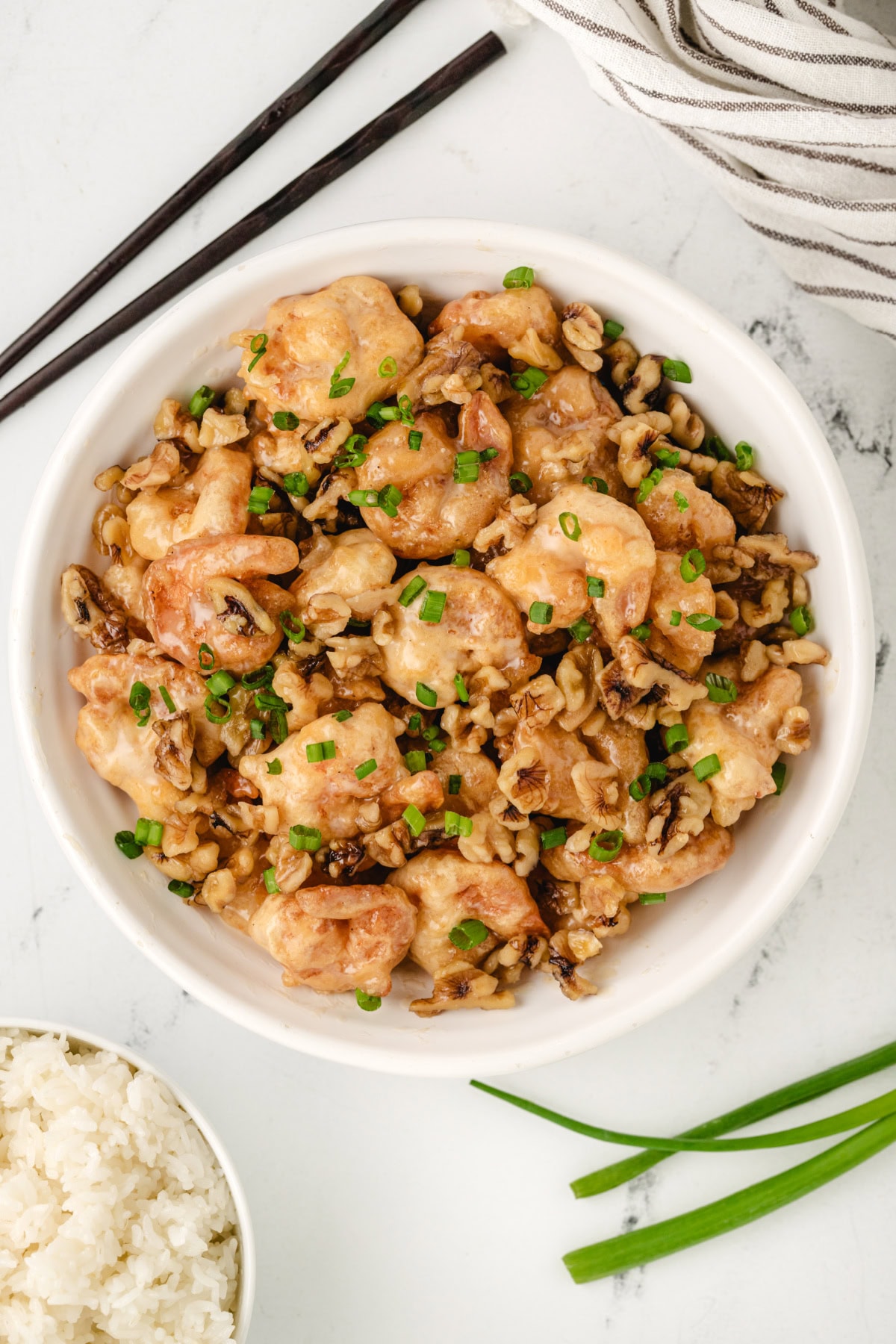 Honey Walnut Shrimp recipe from RecipeGirl.com : This easy to make Asian meal is crispy shrimp in a sweet, creamy sauce with candied walnuts. It's a popular Chinese takeout recipe. overhead shot of honey walnut shrimp in bowl