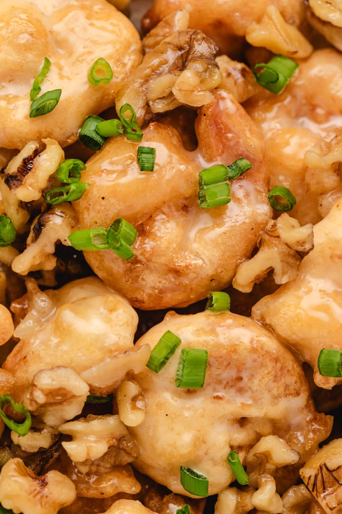 Honey Walnut Shrimp recipe from RecipeGirl.com : This easy to make Asian meal is crispy shrimp in a sweet, creamy sauce with candied walnuts. It's a popular Chinese takeout recipe. close up honey walnut shrimp