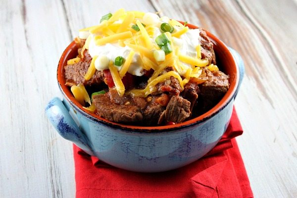Steak and Beer Chili recipe from RecipeGirl.com #steak #beer #chili #RecipeGirl Steak and Beer Chili in a blue bowl on red napkin